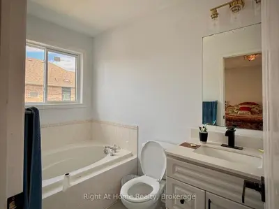 a bathroom with a tub and a toilet and a sink at 3409 McDowell Drive Mississauga Ontario L5M6R7 in Mississauga