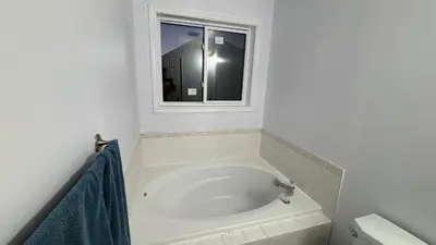 a bath tub in a bathroom with a window at 3409 McDowell Drive Mississauga Ontario L5M6R7 in Mississauga