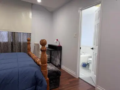a bedroom with a bed with a blue comforter at 3409 McDowell Drive Mississauga Ontario L5M6R7 in Mississauga