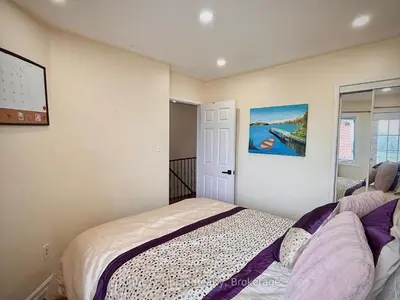 a bedroom with a bed and a painting on the wall at 3409 McDowell Drive Mississauga Ontario L5M6R7 in Mississauga