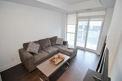 a living room with a couch and a table at The Grand Avenue Suites - Downtown Toronto Entertainment District in Toronto