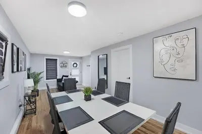 a dining room with a white table and chairs at Welcome To Our Modern 2Bdrm,1Bth w, Laundry,BBQ in Welland