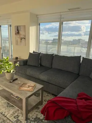 a living room with a couch and a table at Modern Private Room with Ensuite in Vaughan