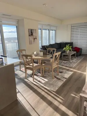 a living room with a table and chairs at Modern Private Room with Ensuite in Vaughan