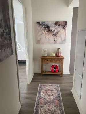 a hallway with a table and a painting on the wall at Modern Private Room with Ensuite in Vaughan