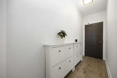a room with white cabinets and a black door at Condo by CN Tower & Rogers Centre in Toronto