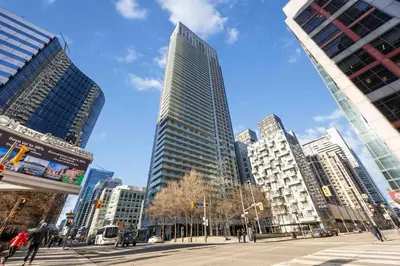 a tall building in a city with buildings at Condo by CN Tower & Rogers Centre in Toronto