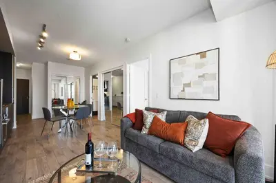a living room with a couch and a table at Condo by CN Tower & Rogers Centre in Toronto