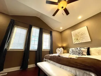 a bedroom with two beds and a ceiling fan at Maison Laurier, Modern 5B4B Home Inc BSMT Free parking, Close to trails in Richmond Hill