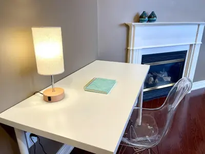a white table with a lamp and a chair at Maison Laurier, Modern 5B4B Home Inc BSMT Free parking, Close to trails in Richmond Hill