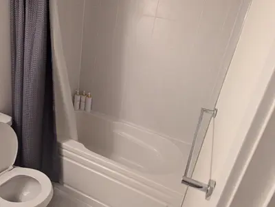 a bathroom with a shower and a toilet at Sunshine room on Downsview in Toronto