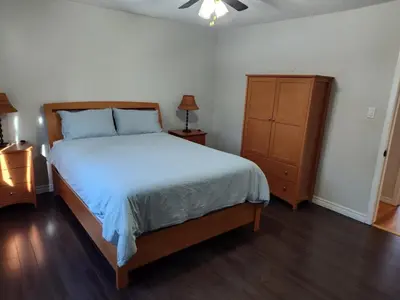 a bedroom with a large bed and a dresser at 3 BDR lake Simcoe cottage-free parking -day pass to provincial park-one hour from Toronto in Georgina