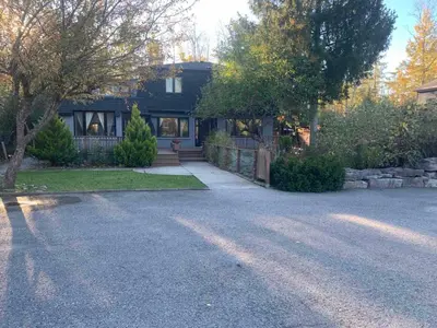 a house with a driveway in front of it at 3 BDR lake Simcoe cottage-free parking -day pass to provincial park-one hour from Toronto in Georgina