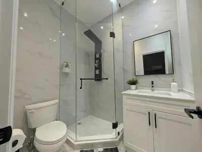 a bathroom with a shower and a toilet and a sink at Luxury 1BR plus den walkout basement in Toronto