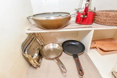 a sink in a kitchen with two spoons and a pan at Entire 4BR 3BA Home in Mississauga, Sleeps 8, 10 mins to Pearson Airport in Mississauga