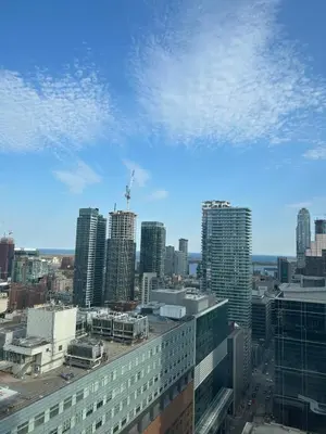 a view of a city skyline with tall buildings at Cozy & Elegant Condo-Lake & City View-35th floor in Toronto