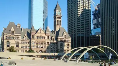 a large building with a clock tower in a city at Cozy & Elegant Condo-Lake & City View-35th floor in Toronto