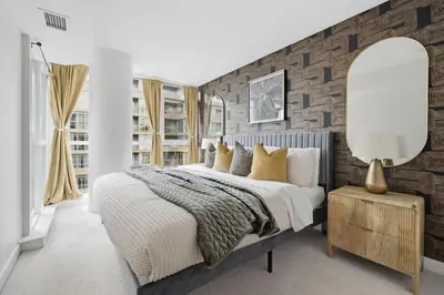 a bedroom with a large bed and a brick wall at Upscale King Suite Near CN Tower with Free Parking in Toronto