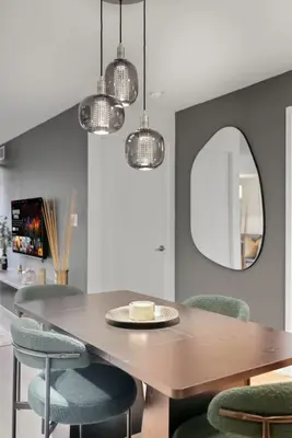 a dining room with a table and chairs and a mirror at Upscale King Suite Near CN Tower with Free Parking in Toronto