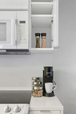 a kitchen with a coffee maker and a microwave at Upscale King Suite Near CN Tower with Free Parking in Toronto