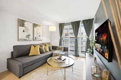 a living room with a couch and a table at Upscale King Suite Near CN Tower with Free Parking in Toronto