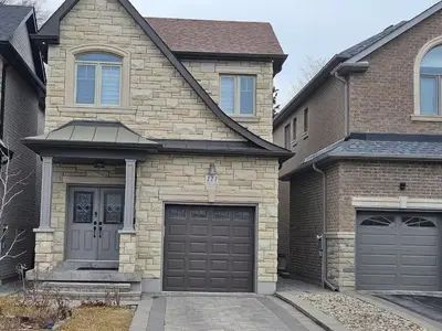 a brick house with two garage doors at Ensuite in New Home with Parking, Close to Bluffers Park, Lake Ontario, 15 Mins to Downtown in Toronto