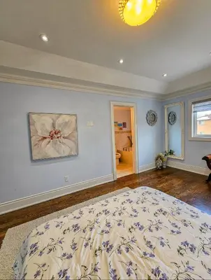 a bedroom with a large bed in a room at Ensuite in New Home with Parking, Close to Bluffers Park, Lake Ontario, 15 Mins to Downtown in Toronto