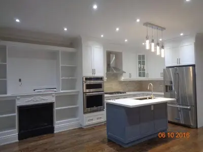 a large kitchen with white cabinets and a sink at Ensuite in New Home with Parking, Close to Bluffers Park, Lake Ontario, 15 Mins to Downtown in Toronto