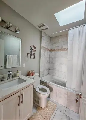 a bathroom with a toilet and a sink and a tub at Ensuite in New Home with Parking, Close to Bluffers Park, Lake Ontario, 15 Mins to Downtown in Toronto