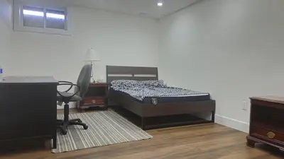 a bedroom with a bed and a desk and a chair at Forest city family style furnished rooms in London