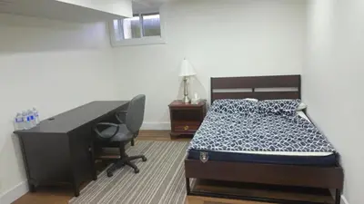a bedroom with a bed and a desk and a desk at Forest city family style furnished rooms in London