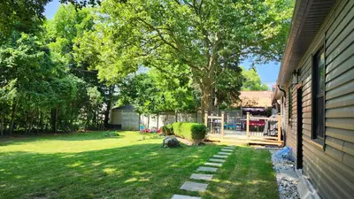 a yard with a fence and a tree at Forest city family style furnished rooms in London
