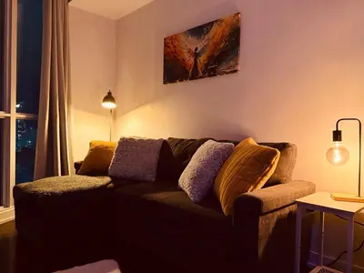 a living room with a couch and a painting on the wall at Skyline Suite 1-Bed Penthouse in heart of Downtown Toronto in Toronto