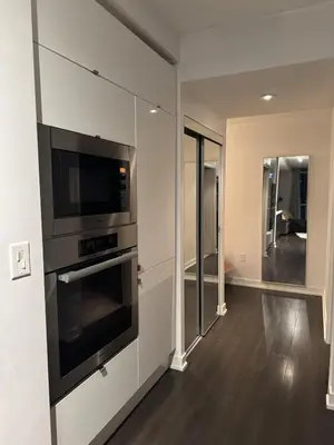 a kitchen with a stove and a microwave at Skyline Suite 1-Bed Penthouse in heart of Downtown Toronto in Toronto
