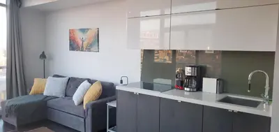 a living room with a couch and a kitchen at Skyline Suite 1-Bed Penthouse in heart of Downtown Toronto in Toronto