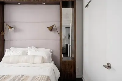 a bedroom with a white bed and a mirror at Elegant Sunset Lake View Suite with Parking in Toronto
