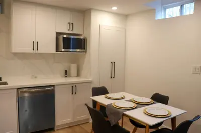 a kitchen with a table and chairs in a room at Luxury Brand-New Spacious Apartment in Richmond Hill in Richmond Hill