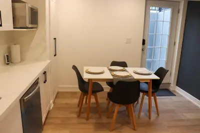 a kitchen with a table and chairs in a room at Luxury Brand-New Spacious Apartment in Richmond Hill in Richmond Hill