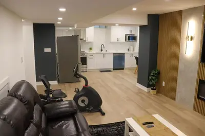 a living room with a couch and a kitchen at Luxury Brand-New Spacious Apartment in Richmond Hill in Richmond Hill