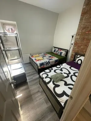 a bedroom with two beds and a ladder at Toronto Downtown Holiday Home-Private Patio,Free Wifi & Self Checkin in Toronto