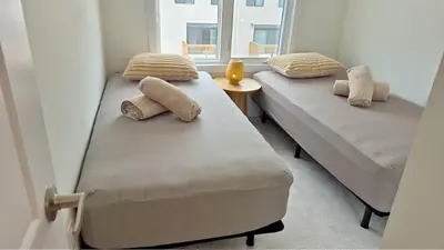 two beds in a room with a window at Nordic Three Brantford in Brantford