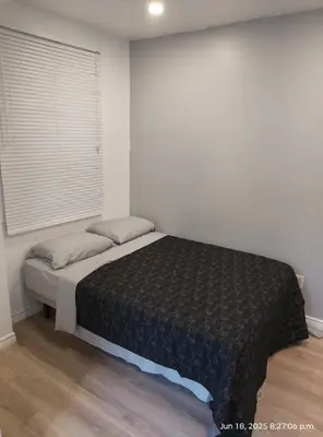 a bedroom with a bed in a room with a window at Midtown Toronto studio in Toronto