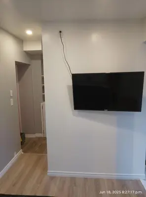 a flat screen tv hanging on a white wall at Midtown Toronto studio in Toronto