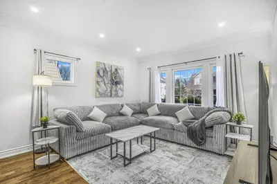 a living room with a couch and a table at Romeo & Juliet Niagara Retreat - Clifton Hill in Niagara Falls