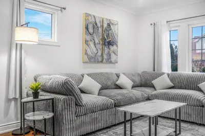 a living room with a couch and two tables at Romeo & Juliet Niagara Retreat - Clifton Hill in Niagara Falls