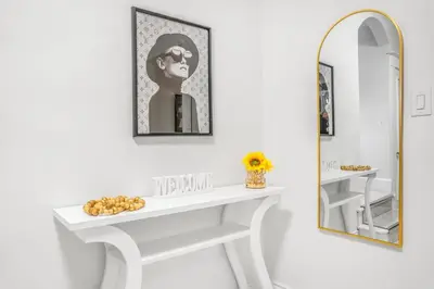 a bathroom with a white sink and a mirror at Romeo & Juliet Niagara Retreat - Clifton Hill in Niagara Falls
