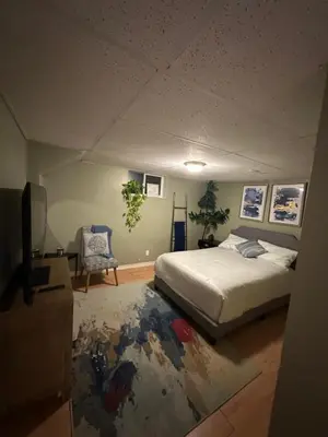 a bedroom with a bed and a tv in it at 1 Bedroom Apartment Owen Sound in Owen Sound