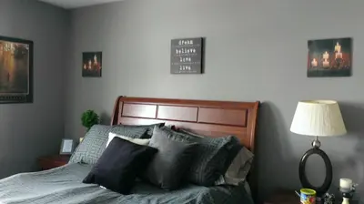 a bedroom with a bed with pillows and a lamp at HB Guest Home 3 in Waterloo