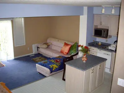 a living room with a couch and a kitchen at HB Guest Home 3 in Waterloo