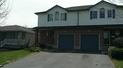 a house with two garage doors in a driveway at HB Guest Home 3 in Waterloo